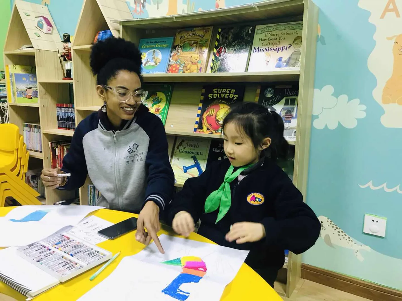 Yaye helping a student in the classroom